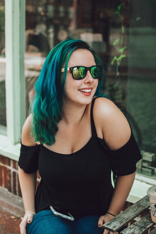 Girl with green hair wearing green polarized wayfarer bamboo sunglasses