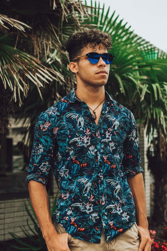 Man in Hawaiian shirt wearing blue polarized zebra wood sunglasses.